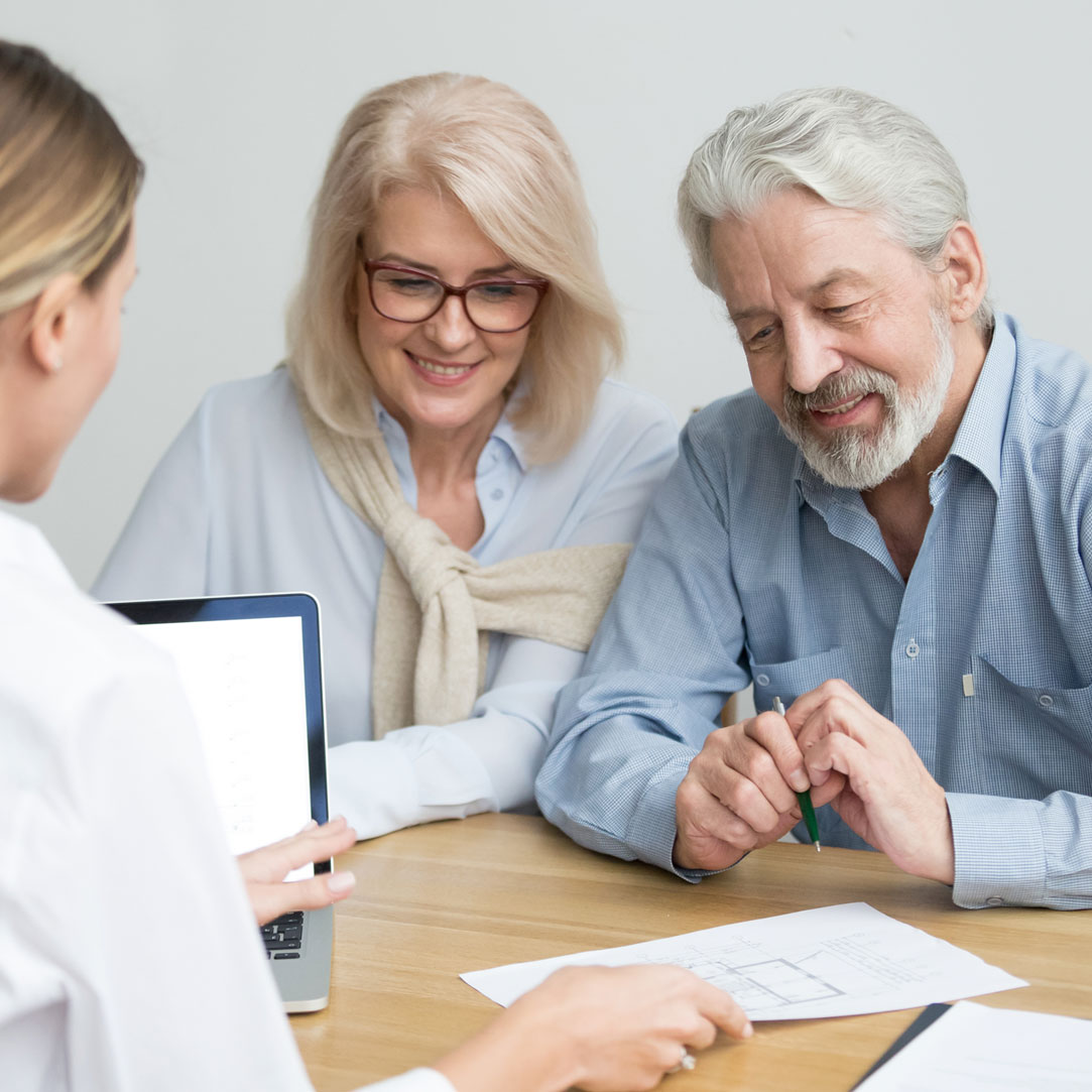 Couple reviewing documents with expert